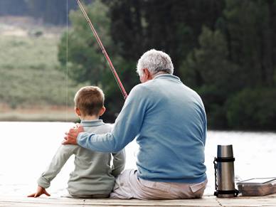 Man and boy fishing in lake