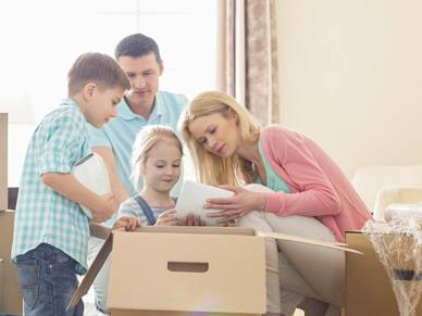 family packing a moving box