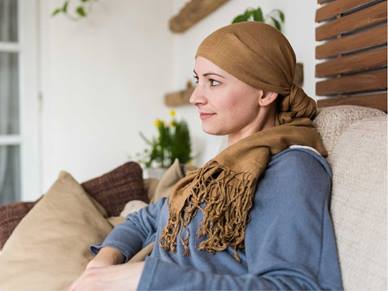 Woman with a scarf watching TV